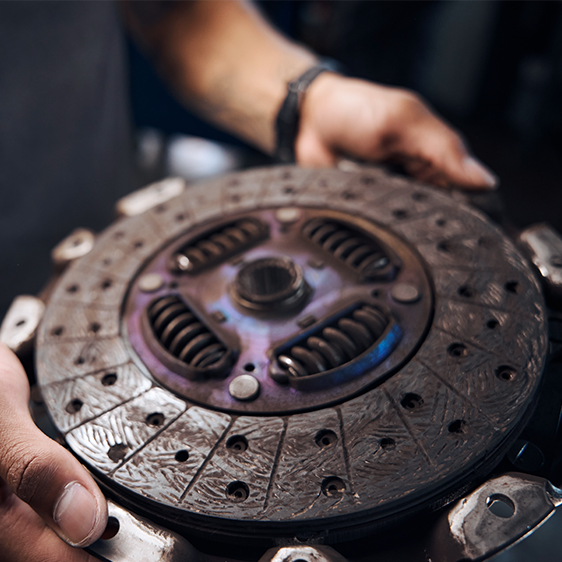 Mechanic holding clutch plate repair